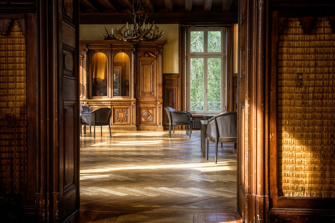Salón moderno con suelo de parquet de madera clara y luz natural, mostrando mobiliario susceptible al aire acondicionado